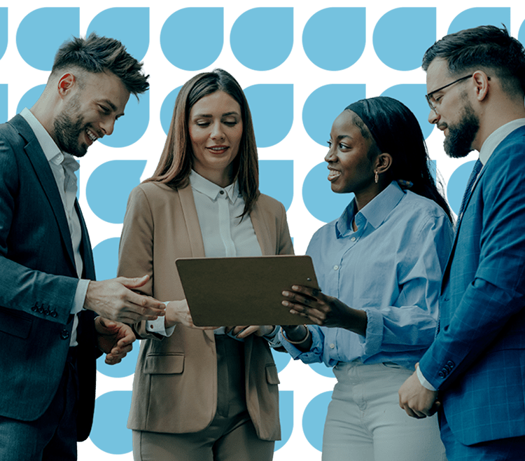 Group of people looking over a laptop screen together